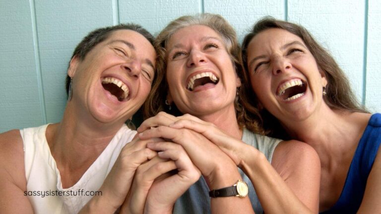three middle aged women laughing hysterically about the funny facts about aging.