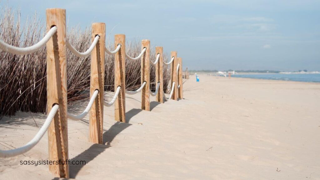 a beautiful beach with a pole and rope fence to show a boundary.