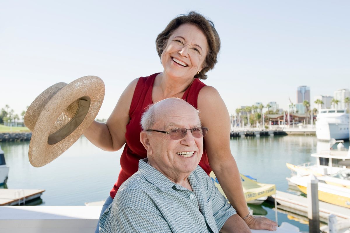Older couple near a marina smiling