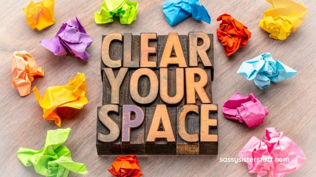 top view of wooden blocks that say CLEAR YOUR SPACE with crumpled up sticky notes laying around it.