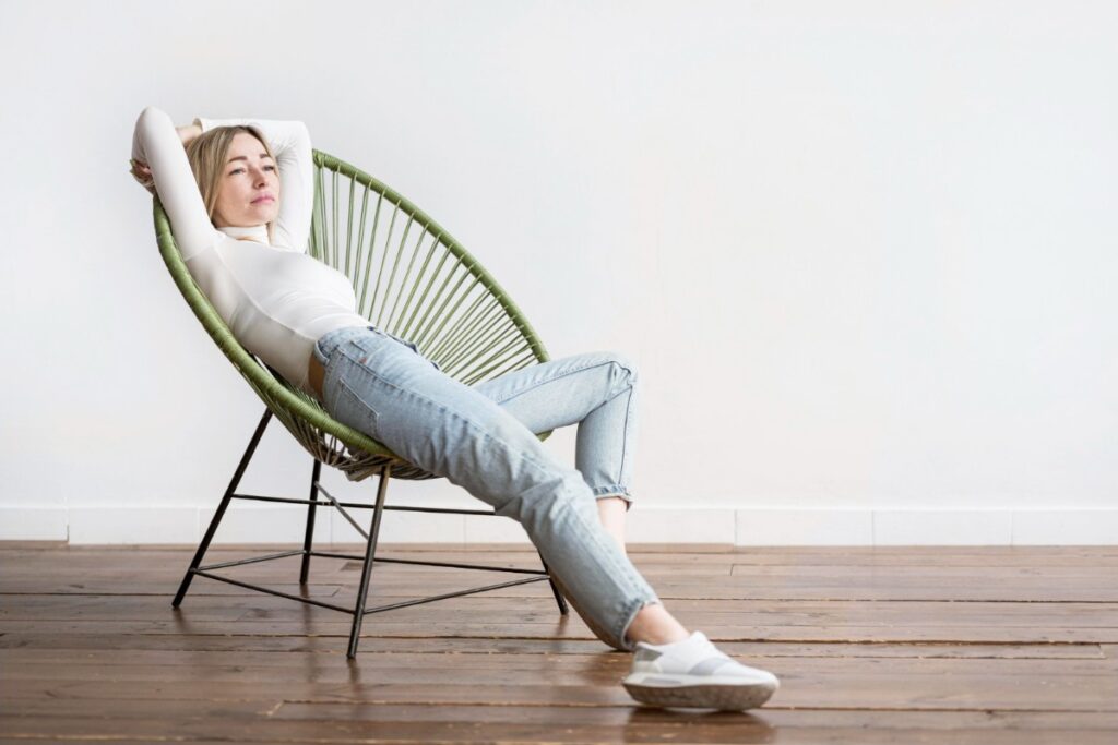 Slouching heavily in their chair
