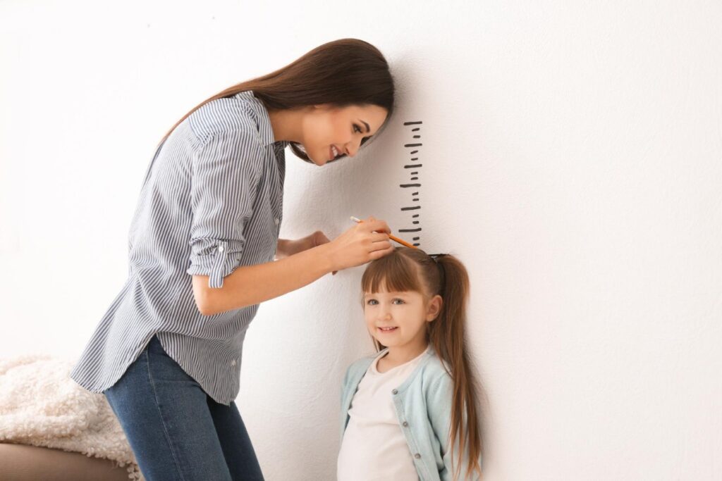 Tracking their growth on the wall