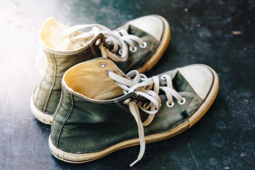 Wearing worn-out sneakers