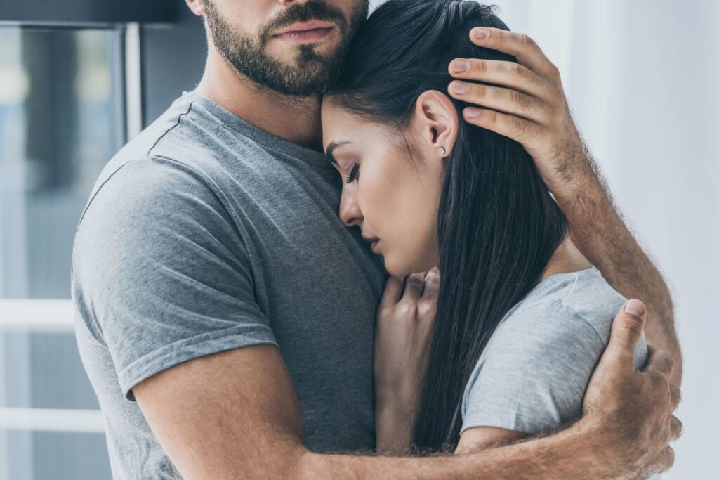 man holding a woman to his chest