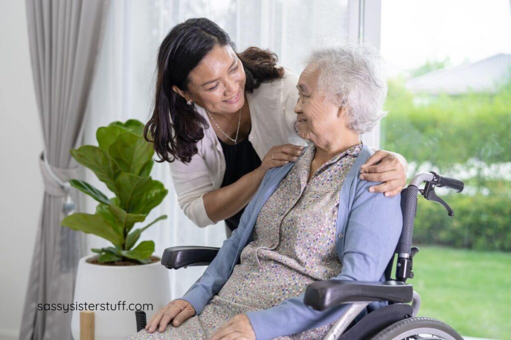 elderly woman in a wheel chair cheerfully asks another woman for help.