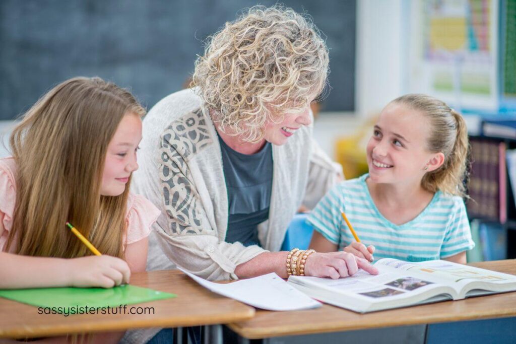 female student asks an adult volunteer for help with her assisgnment.