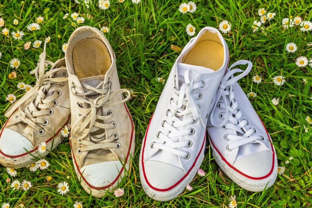A pair of clean and dirty sneakers on the grass 