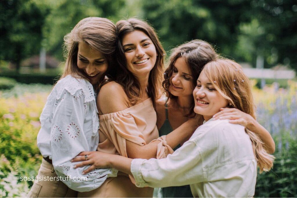 a group of four mixed-age woman ijug n a lovely green carden.
