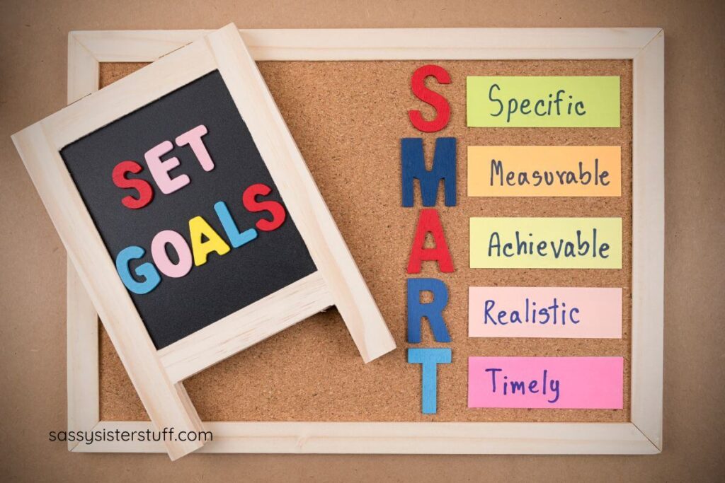 a bulleting board that says SET GOALS and defines SMART goals.