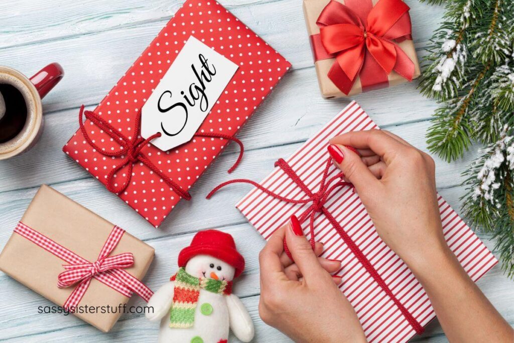 female hands wrapping 5 senses gift ideas for Christmas.