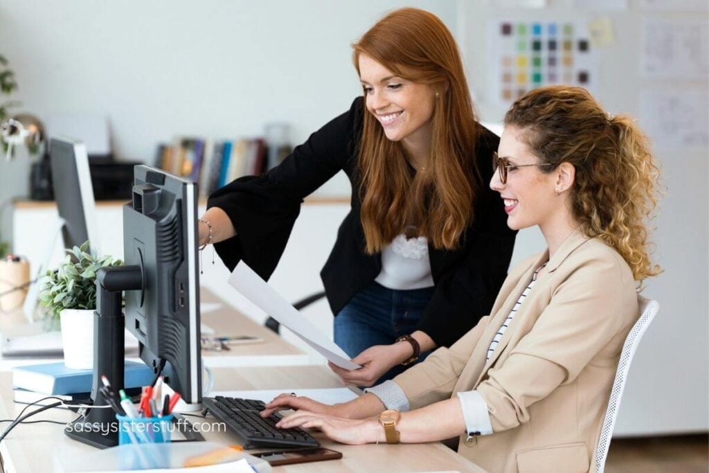 two women working on a project at a computer.