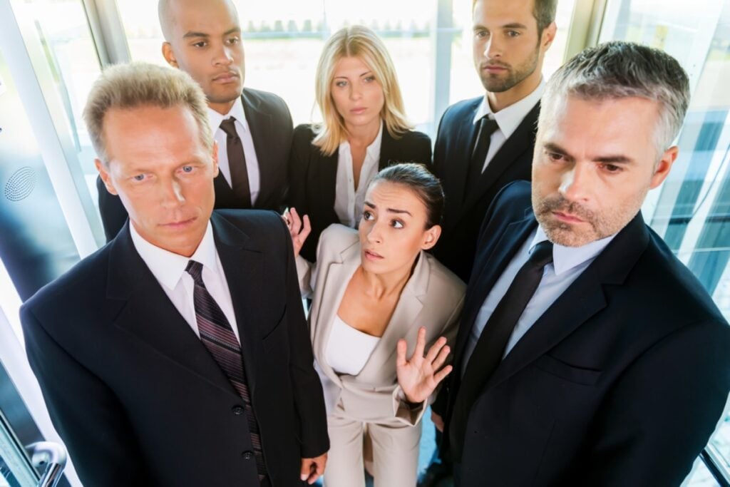 Elevator stops unexpectedly, and everyone freezes.