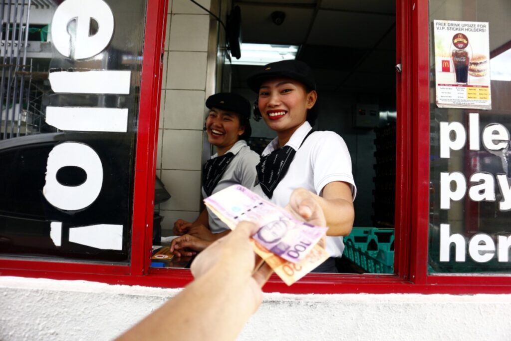 Fumbling with cash at the window like you’re auditioning for a magic show