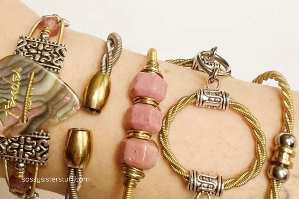 five bracelets made of guitar strings and beads that are perfect for giving art as a gift.