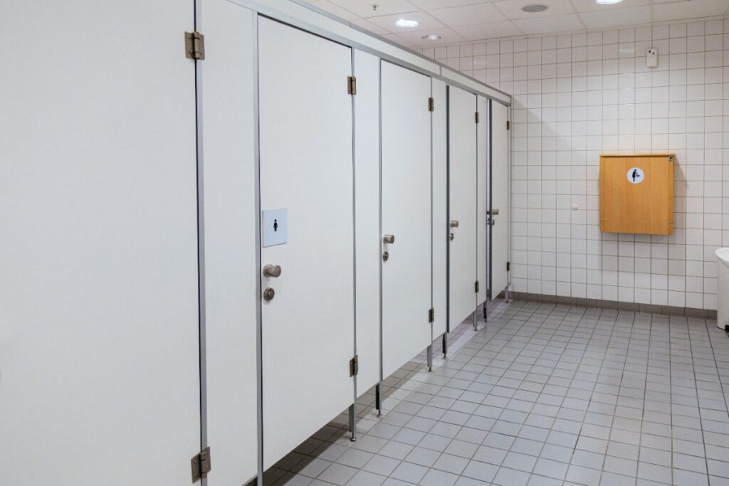 Hearing someone sing or talk loudly inside a stall