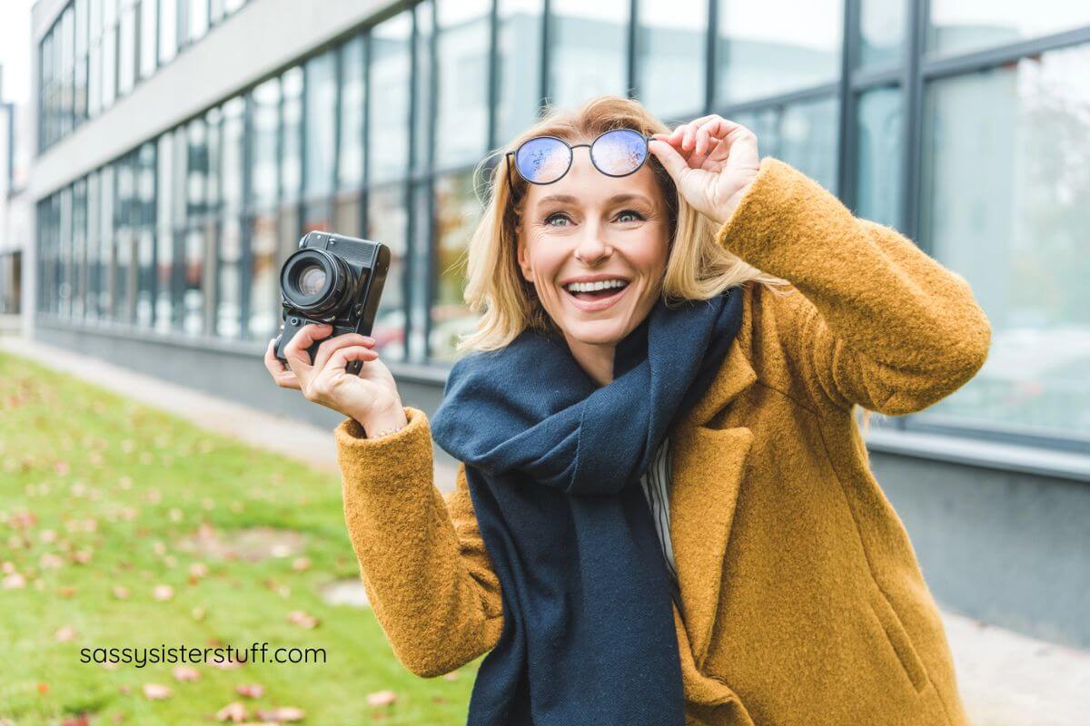 happy middle aged women practicing her photography skills.