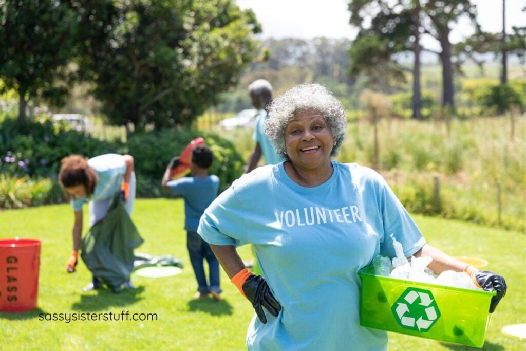 happy middle aged African American woman volunteers in her community to clean up the park.