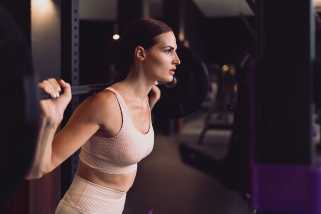 Making exaggerated facial expressions while lifting weights