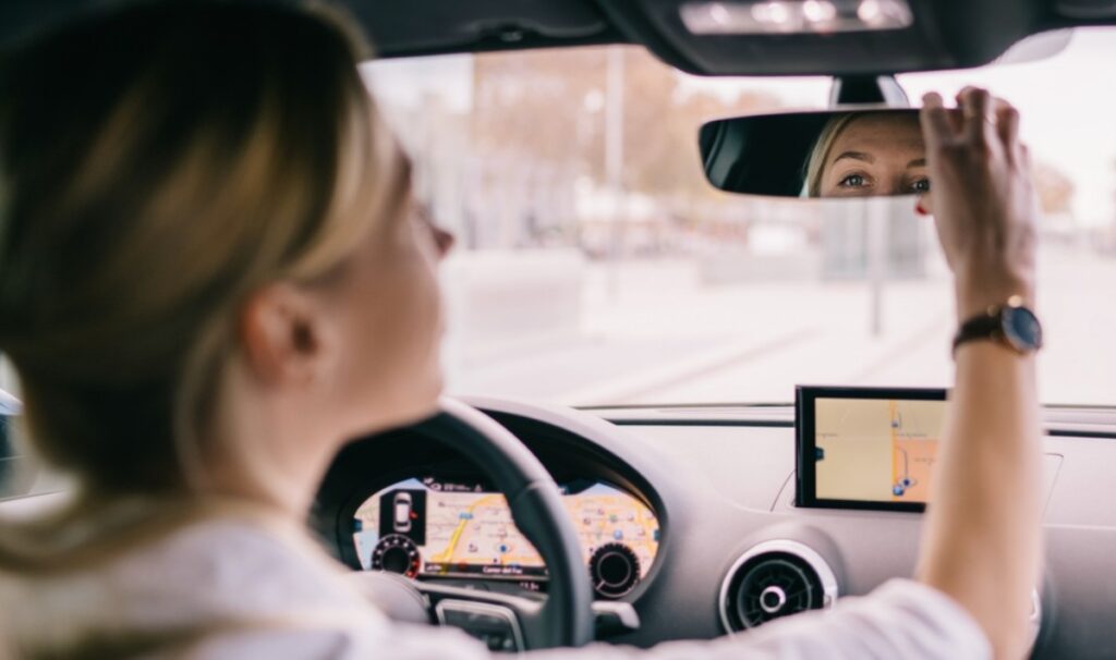 Making goofy faces in the rearview mirror