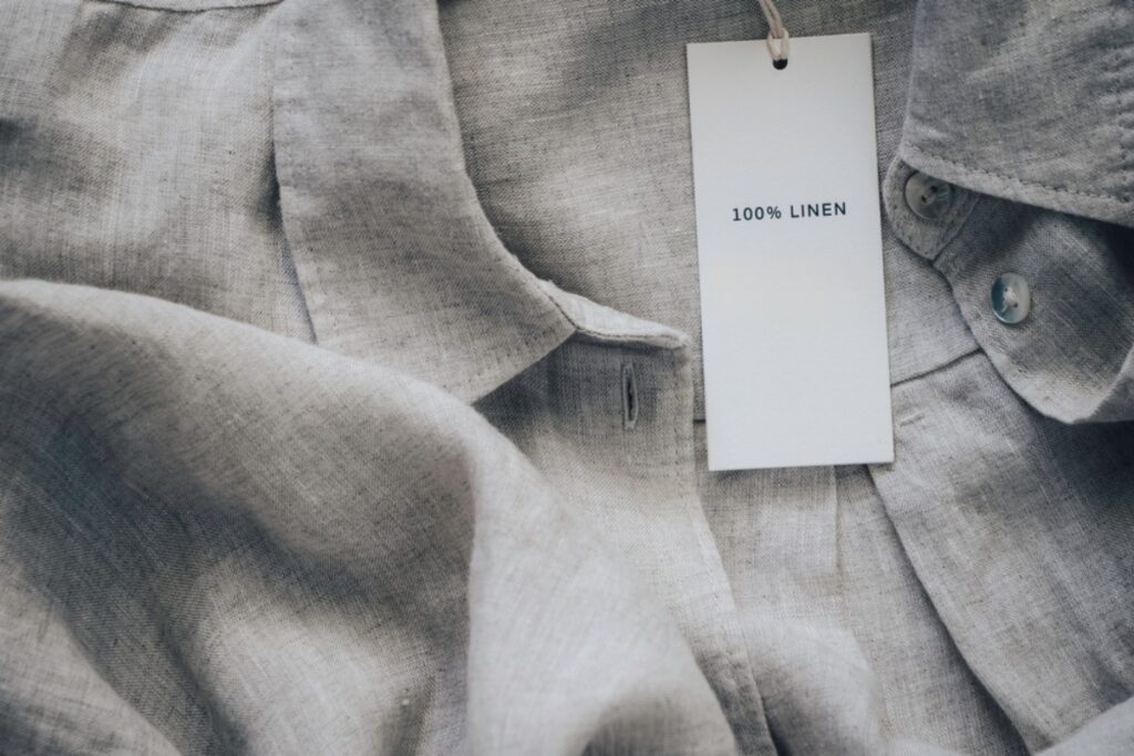 Sniffing clothing tags to check if it smells fresh or used