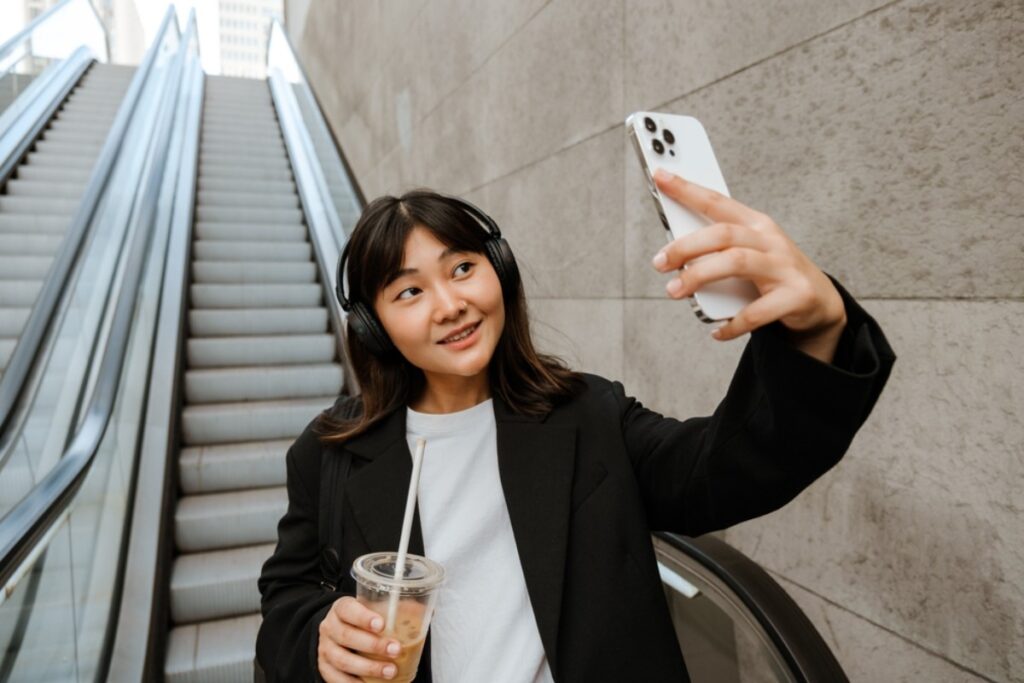 Stopping mid-escalator and pulling out a phone for a dramatic selfie