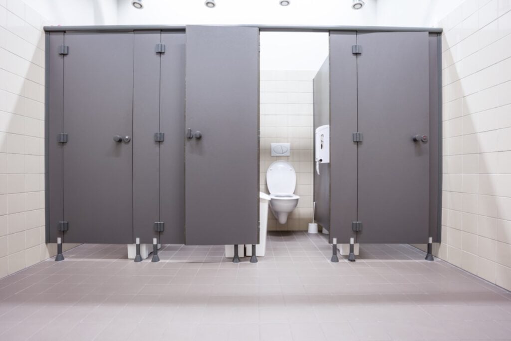 Trying to quietly open a noisy restroom door