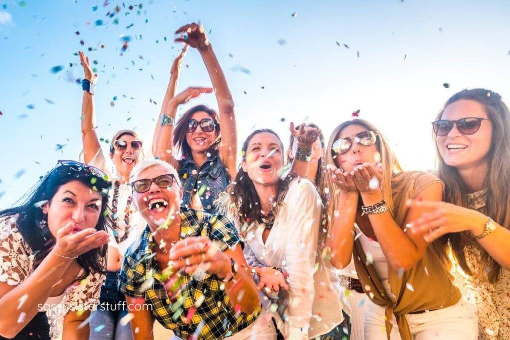 eight women in midlife celebrate the changes that come with age by throwing confetti up in the sky.