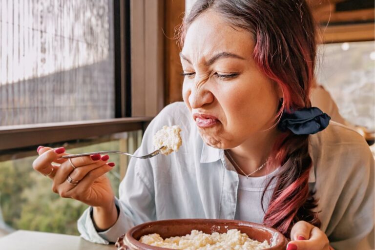 woman eating food she is not enjoying -