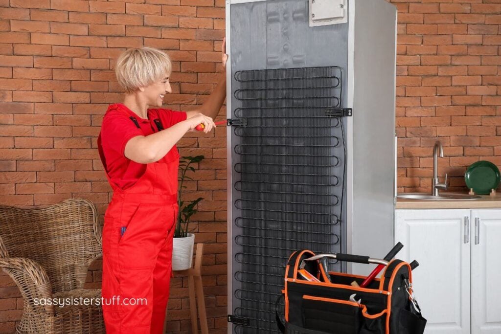woman repairing a refridgerator.