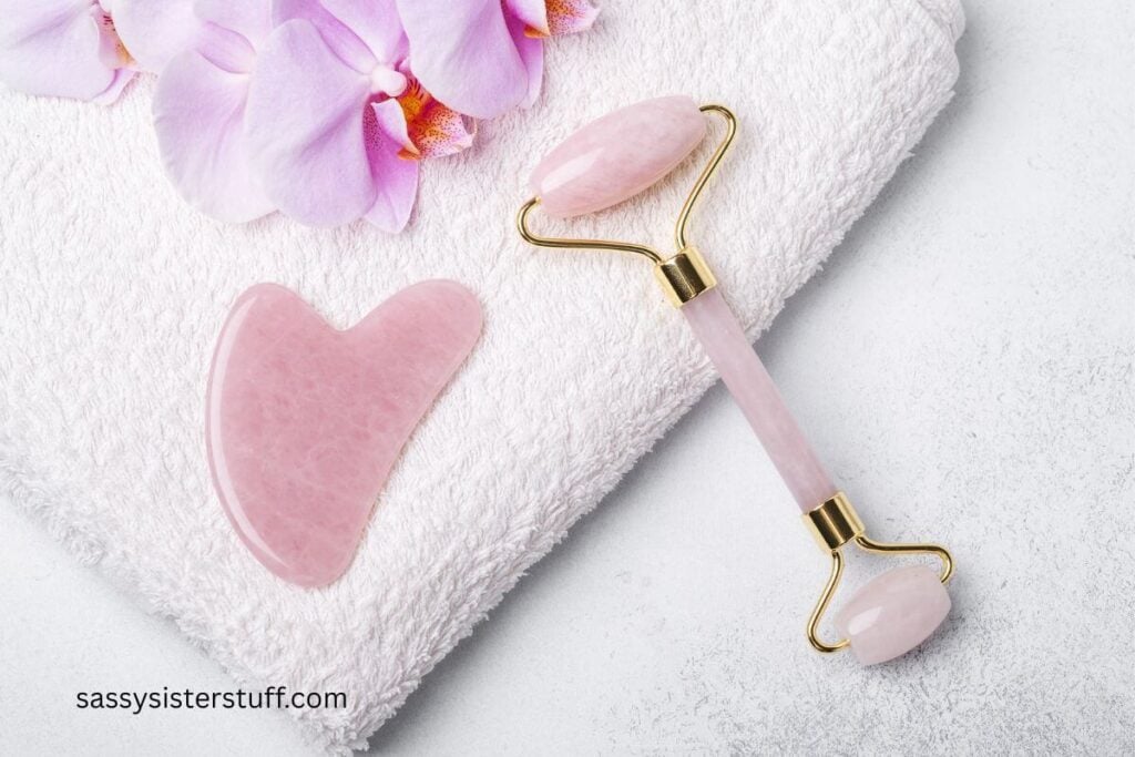 gua sha and roller laying on a white towel.