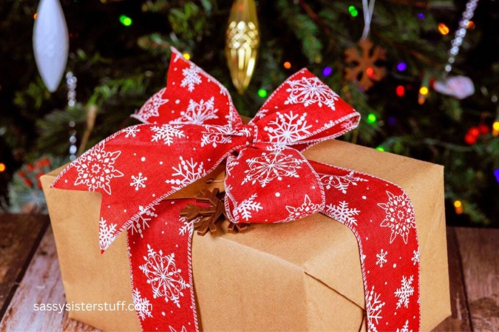 Christmas gift with large red bow under the Christmas tree.