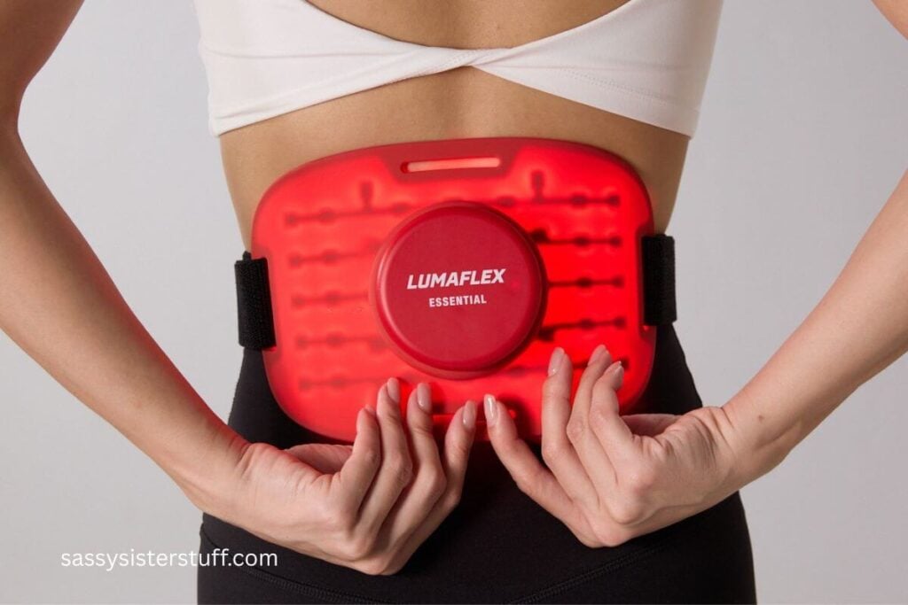 woman doing lumaflex red light therapy on her back.