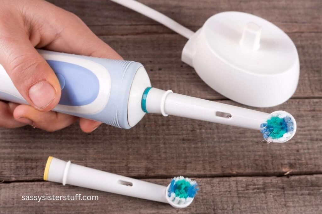 someone holding an electric toothbrush.