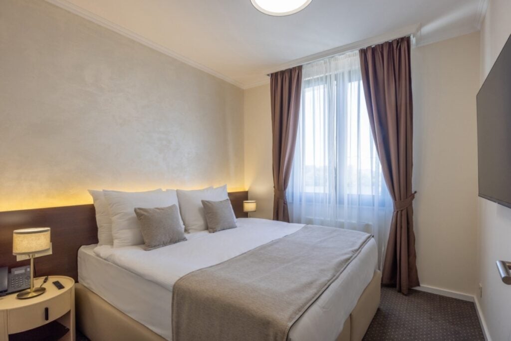 Create a cozy guest room with a plush mattress and layered bedding