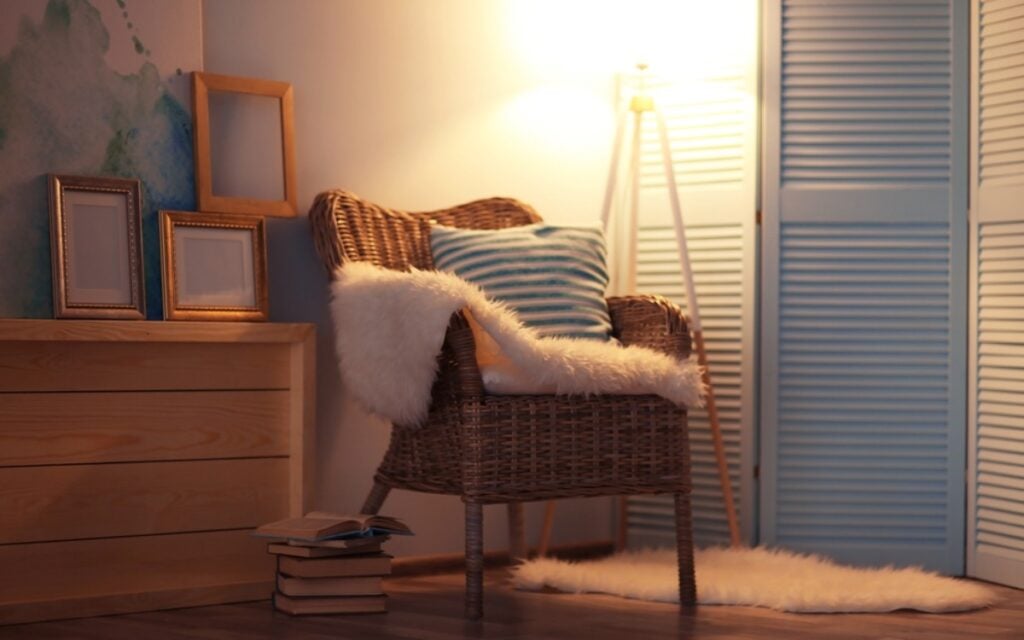 Design a reading nook with a comfy armchair and adjustable lighting