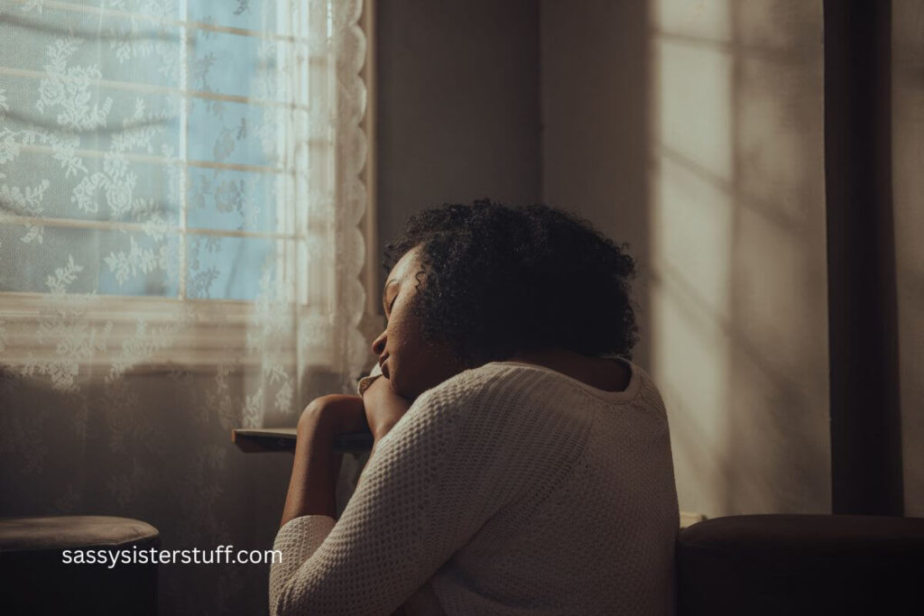 midlife woman with her eyes closed and her head resting on her arm on a table because she's unable to recognize when you're lonely.