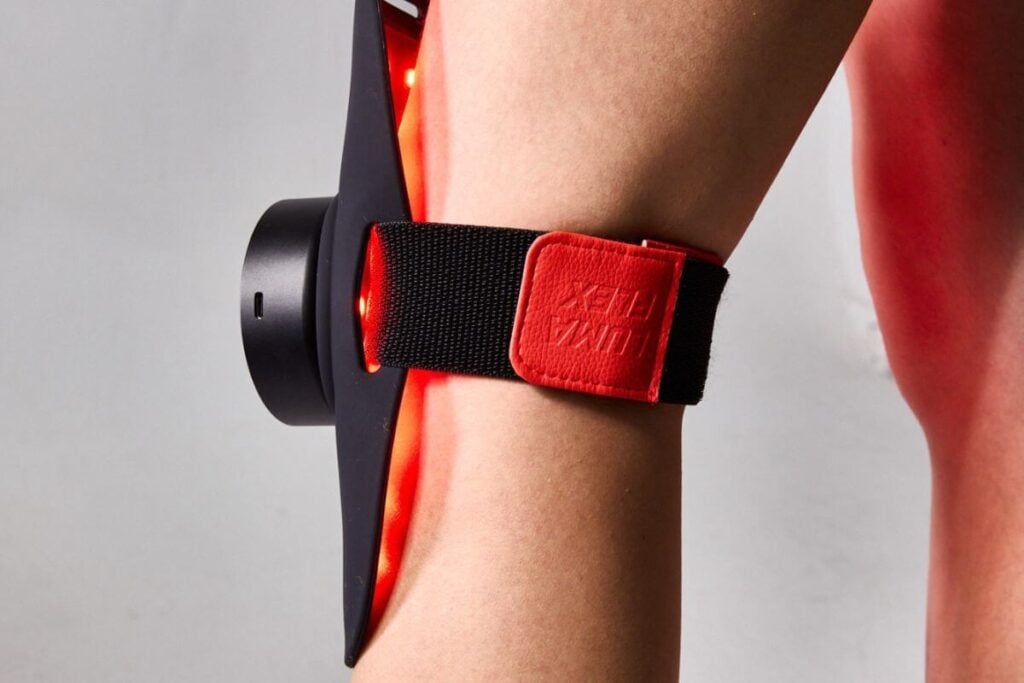 Lumaflex red light therapy on someone's knee.