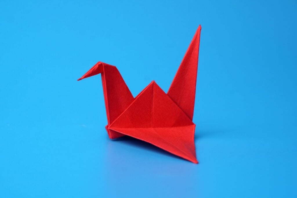 Miniature folded origami crane