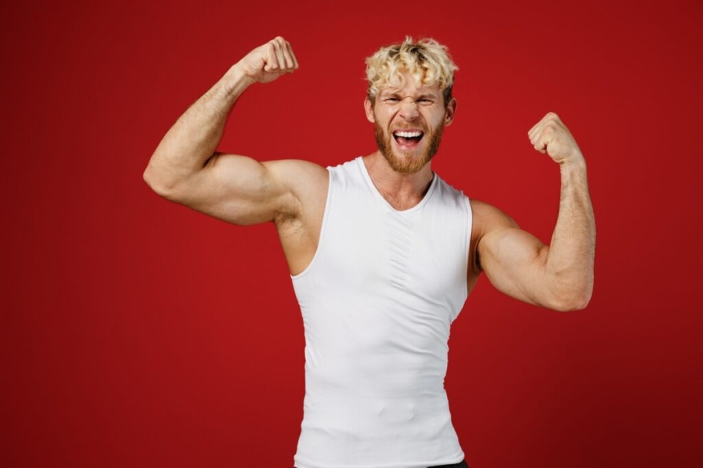 Practicing victory poses like a bodybuilding champion