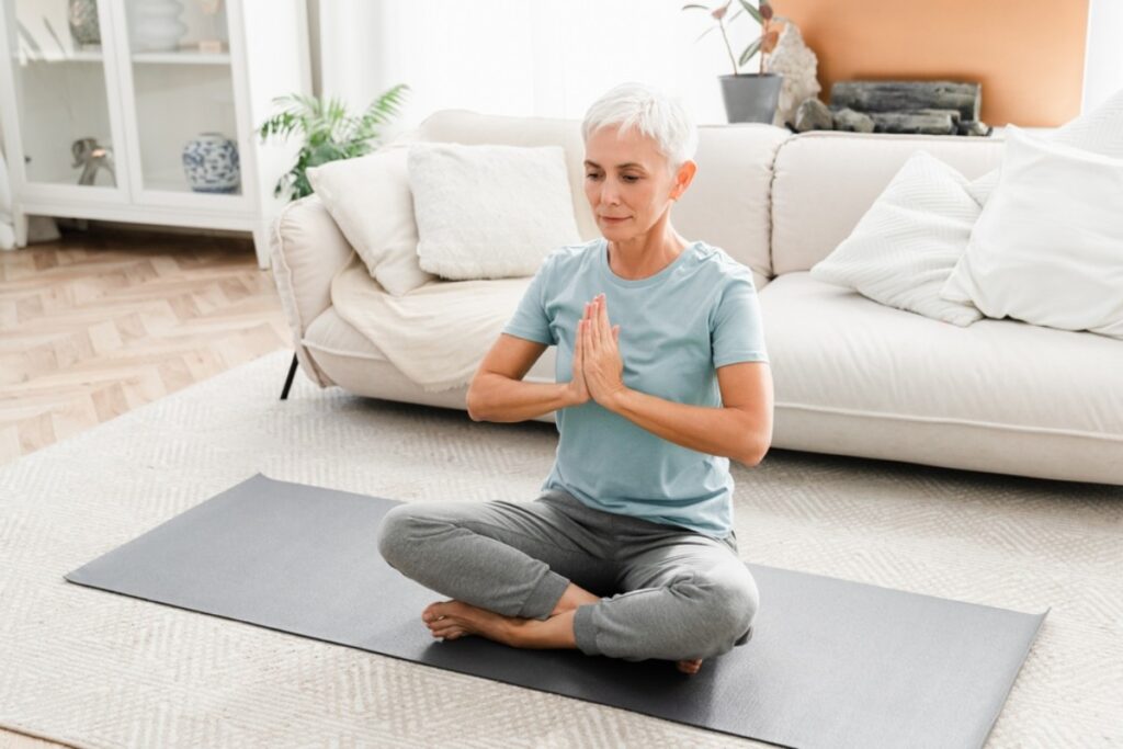 Practicing yoga or gentle stretching in a sunlit room