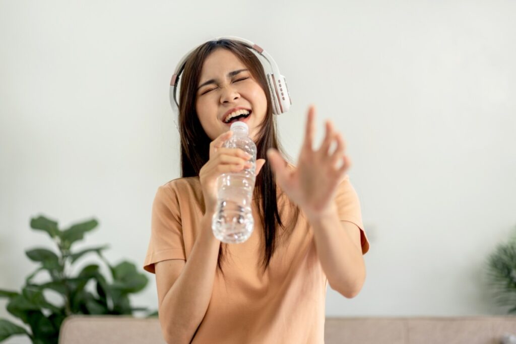 Pretending the water bottle is a microphone