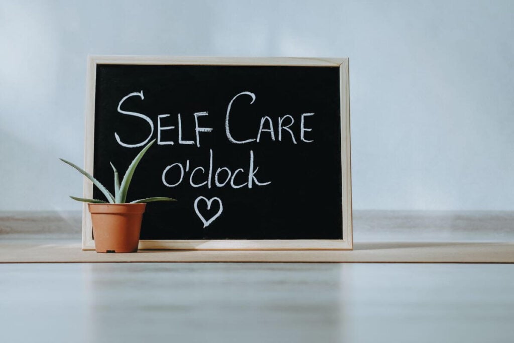 a small tabletop chalkboard that said Self Care o'clock.