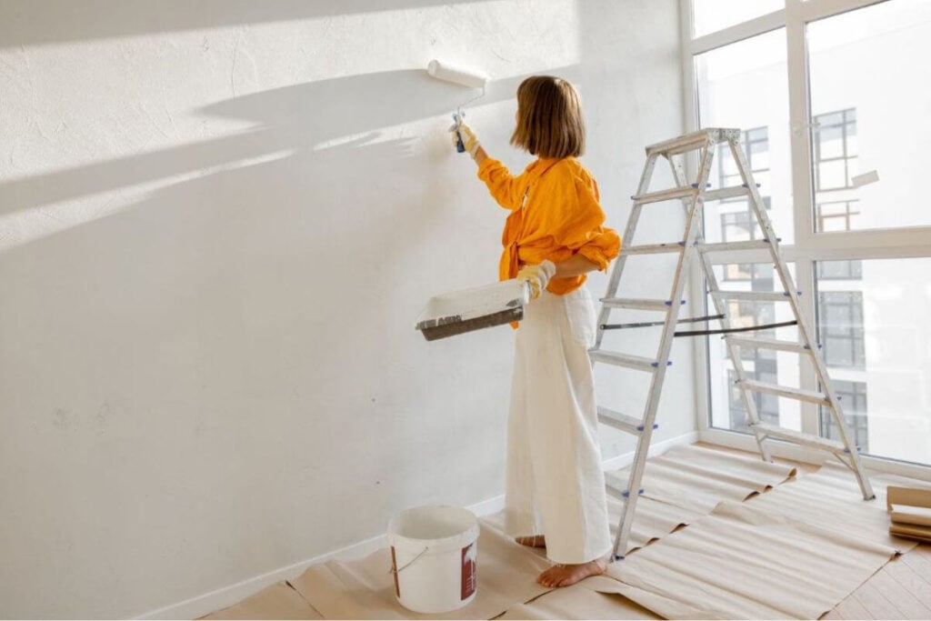 midlife adult daughter repaints a bedroom for her parent.