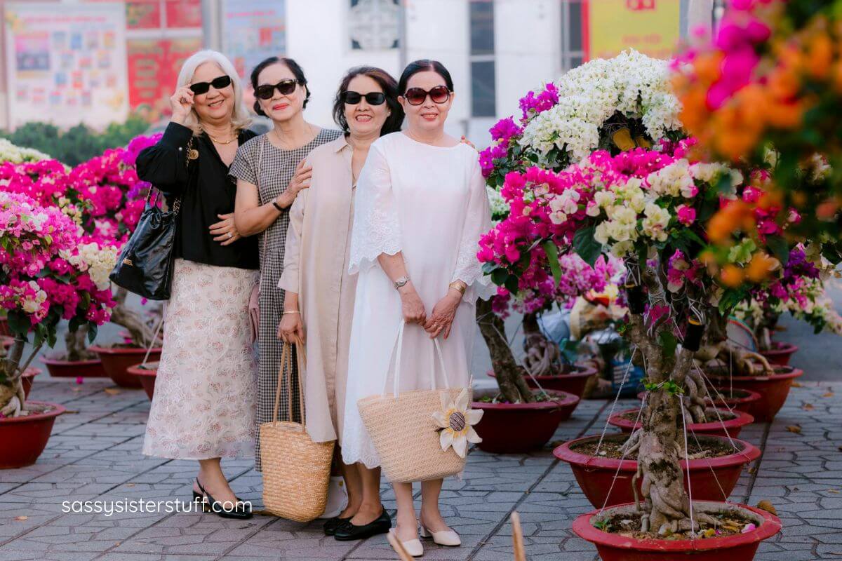 four middle aged women pose for a photo while on vacation together.