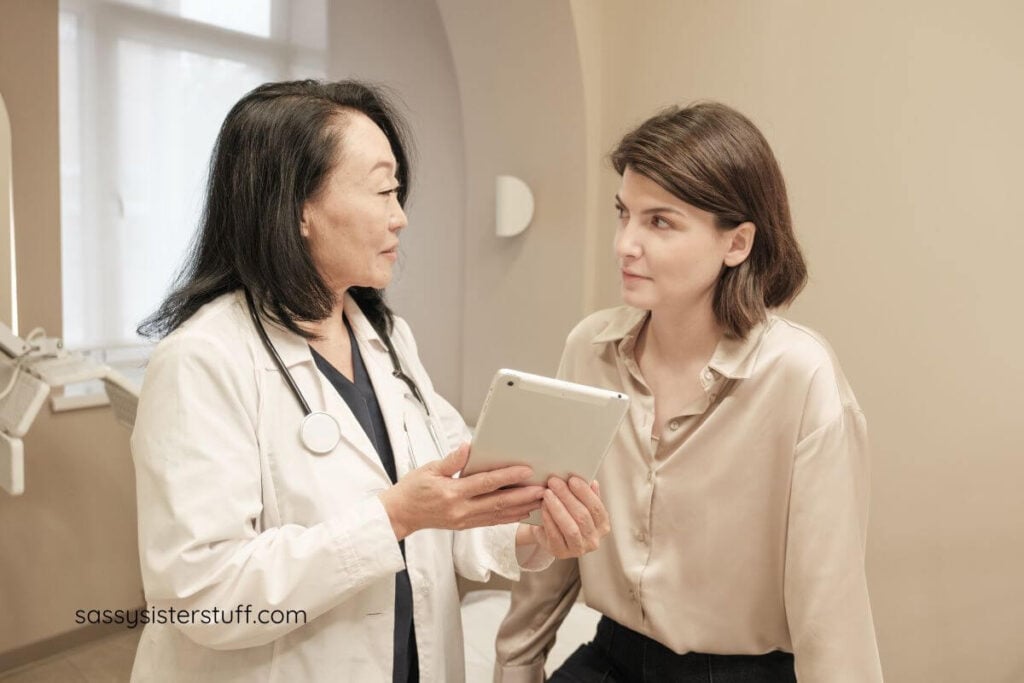 middle aged woman meets with her doctor to discuss a health plan for traveling.