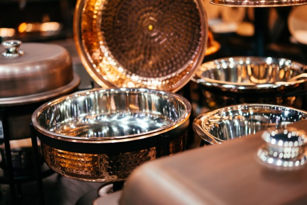 Using chafing dishes to keep food warm at the table