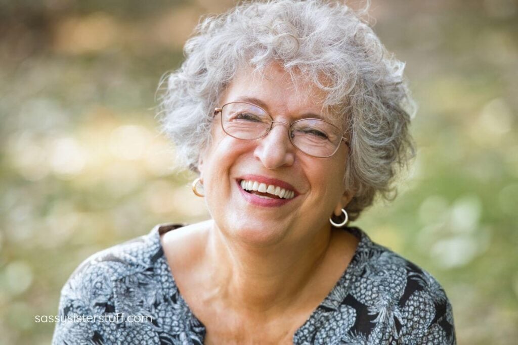 elderly gray hair woman laughs out loud as funny self love quotes.