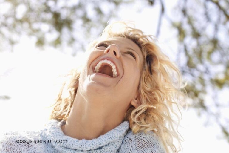 middle aged woman laughs out loud at funny self love quotes.