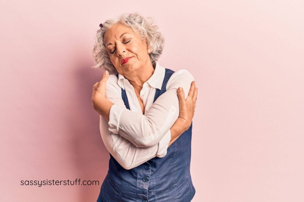 aging woman hugs herself for self care Sunday.
