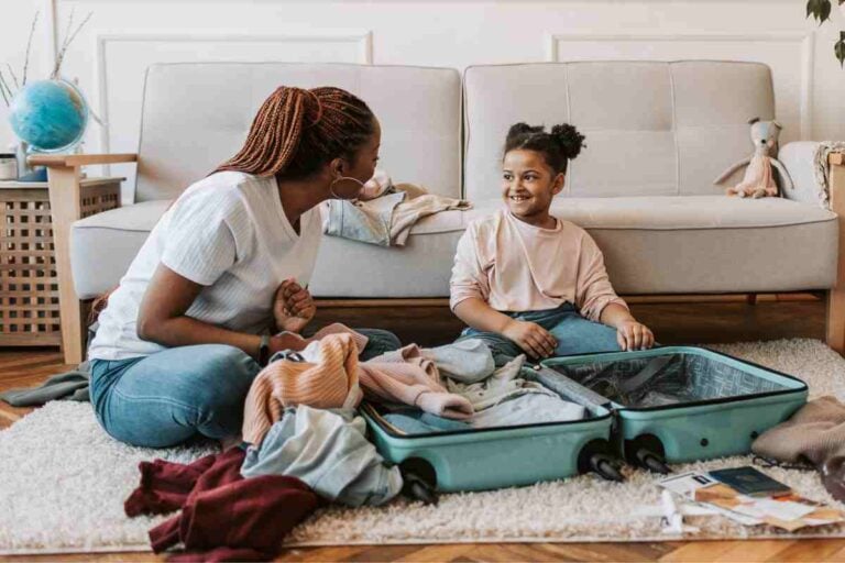 mother and midlife daughter packing for a vacation.